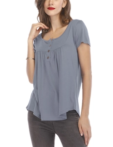 Close-up of wood buttons and pleats on a loose short-sleeved blue-grey T-shirt