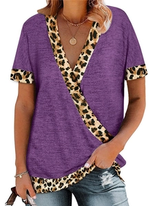 Detail of V-neck stitching with leopard print accents on purple short sleeve top