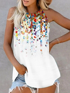 Detail of summer halter top featuring vibrant colorful ink splash print on white fabric