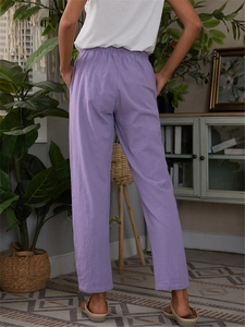 Detail view of purple cotton linen casual trousers with elastic waist and side pockets