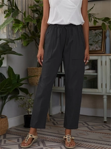 Detailed view of elastic drawstring waist and large side pockets on linen casual pants