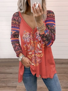 Detail of V-neck button placket and bohemian floral print on waffle knit long sleeve top