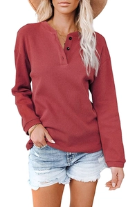 Detailed view of the ribbed texture and black buttons on this brick red Henley top for women