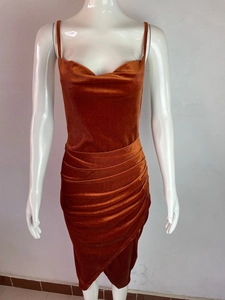 Detailed view of rust red velvet slip dress featuring cowl neck and side ruched draping