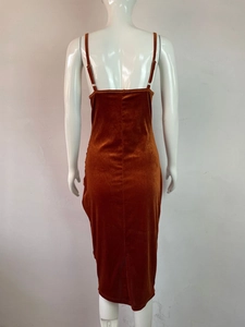 Detail of caramel velvet dress showing the adjustable metal buckles and back texture