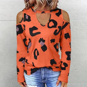 Detail of orange leopard print long sleeve top with cold shoulder cutouts and V-neckline