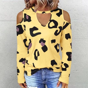 Detail of yellow leopard print cold shoulder top featuring a V-neck cutout and neck strap