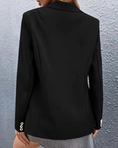 Detailed view of the sleeve cuffs with three golden buttons on this black blazer for women