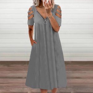 Detail of grey V-neck dress featuring a silver ring zipper and cut-out cold shoulder sleeves