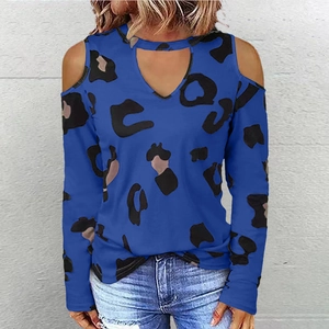 Detail view of royal blue off-shoulder long sleeve top with black leopard print pattern