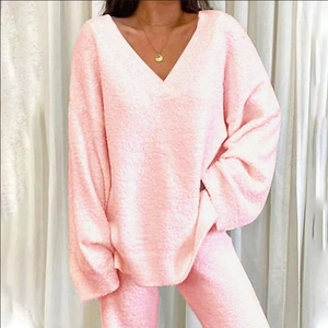Close-up of soft pink V-neck knitted loungewear set with cozy plush fabric texture