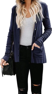 Detail of navy knit cardigan featuring vertical ribbing, white buttons, and front pockets