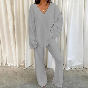 Detail view of light gray fleece loungewear set featuring V-neck top and wide pants