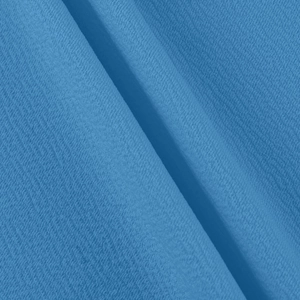 Gros plan détaillé sur la texture du tissu crêpe bleu roi avec un fini grainé élégant