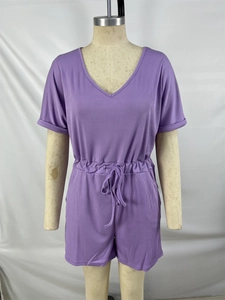 Detail of purple V-neck romper featuring ribbed knit texture and adjustable drawstring waist