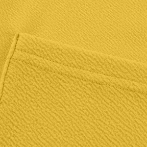 Détail macro de la texture gaufrée jaune et des coutures précises du cardigan pour femme