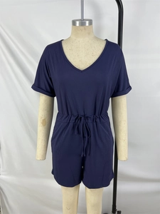 Detail of navy blue ribbed romper with V-neck, elastic drawstring waist and rolled sleeves