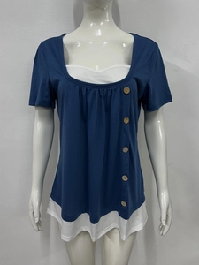 Detail of blue layered t-shirt with pleated neckline and decorative wooden buttons