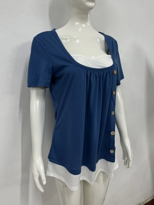 Detail of dark blue pleated short sleeve top with wooden buttons and layered hemline