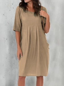 Detail showing pleated cotton linen khaki dress with round neck and side pockets