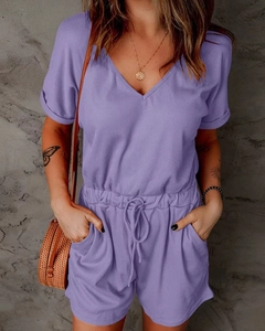 Detail of light purple ribbed knit romper featuring a V-neckline and drawstring waist