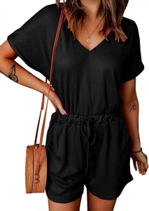 Detail view of black V-neck romper featuring ribbed knit texture and drawstring waist