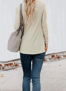 Rear view of a beige ribbed knit cardigan with long sleeves and curved hem design
