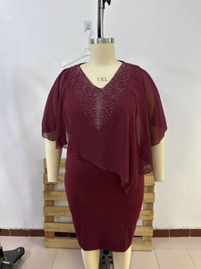 Detail of burgundy chiffon cape dress with elegant rhinestone patterns and V-neckline