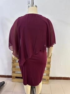 Detail of elegant wine red chiffon cape dress showing the asymmetrical back drape design