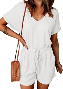 Detail of white V-neck ribbed romper showing drawstring waist and textured fabric