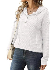 Détail de la maille gaufrée blanche et du col en V boutonné sur le sweat à capuche