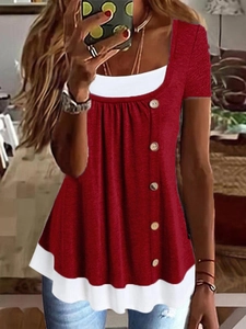 Detail of red faux two-piece t-shirt with white trim, button accents and pleated texture