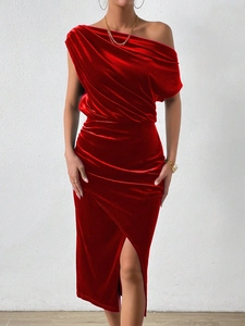 Detail of red velvet off-shoulder dress with elegant draping and high side slit