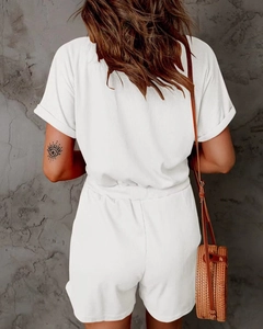 Rear view of white ribbed romper with elastic waist and textured fabric detail