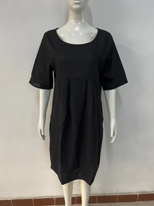 Detail view of cotton linen midi dress showing high waist pleats and side pockets