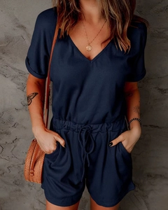 Close-up of navy rib-knit romper featuring a V-neck and adjustable drawstring waist