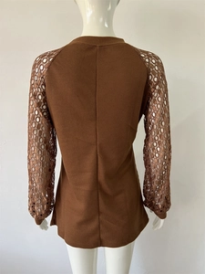 Close-up of brown waffle knit top featuring intricate lace patchwork sleeves and texture