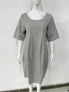 Detail view of cotton linen dress featuring vertical pleats and practical side pockets