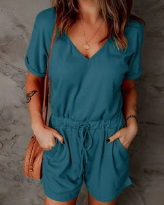 Detail of teal V-neck romper featuring vertical ribbed texture and drawstring waist