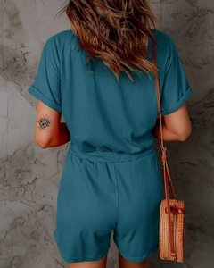 Detail showing vertical ribbed texture and elastic waist of navy blue romper jumpsuit