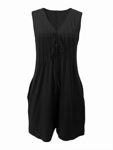 Detail of black sleeveless V-neck romper featuring pleated drawstring and soft fabric