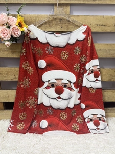 Detailed view of the Christmas knit fabric featuring Santa Claus prints and golden snowflakes