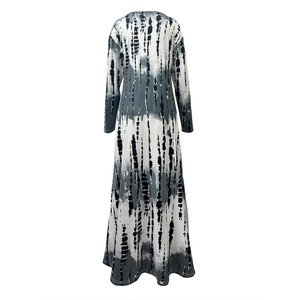 Detail of the tie-dye pattern on a long sleeve V-neck maxi dress with side slit