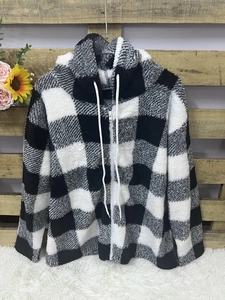 Detail of the black and white buffalo plaid fuzzy hoodie with drawstring and zipper