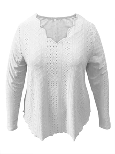 Detail of white scallop V-neckline and intricate hollow floral embroidery on long sleeves