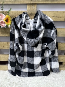 Close-up of black and white checkered fleece hoodie with a white zipper detail