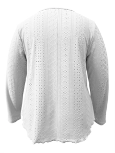 Detail view of white long-sleeved top with hollow geometric texture and rounded hem design