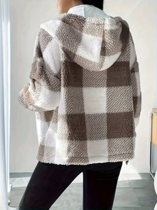 Detail of soft brown and white checkered faux fur texture on a hooded zip-up jacket