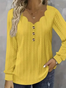 Women's yellow long sleeve knit top with scalloped V-neck and decorative buttons