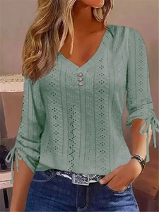 Women's green V-neck hollow knit top with decorative buttons and tied cuffs